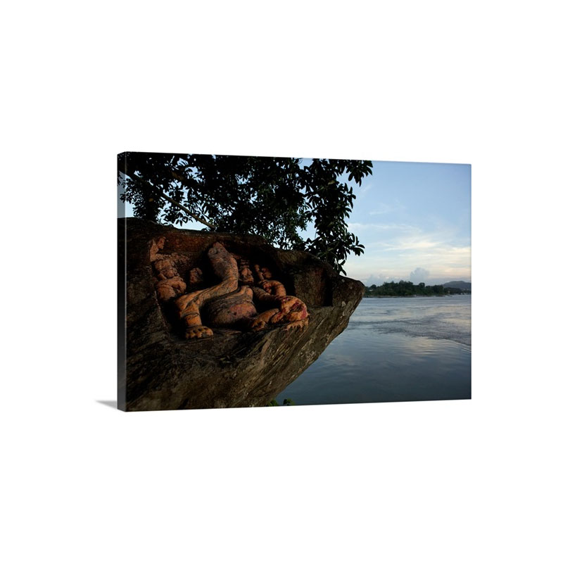 A carving Of Ganesha On A Rock Jutting Into The Brahmaputra River Wall Art - Canvas - Gallery Wrap