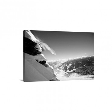 A Snowboarder Jumps Off A Cliff Into Powder In Colorado Wall Art - Canvas - Gallery Wrap