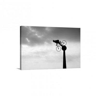 Silhouette Of Cyclist Sculpture With Moody Red Sunset And Cloudy Sky Vehind Wall Art - Canvas - Gallery Wrap